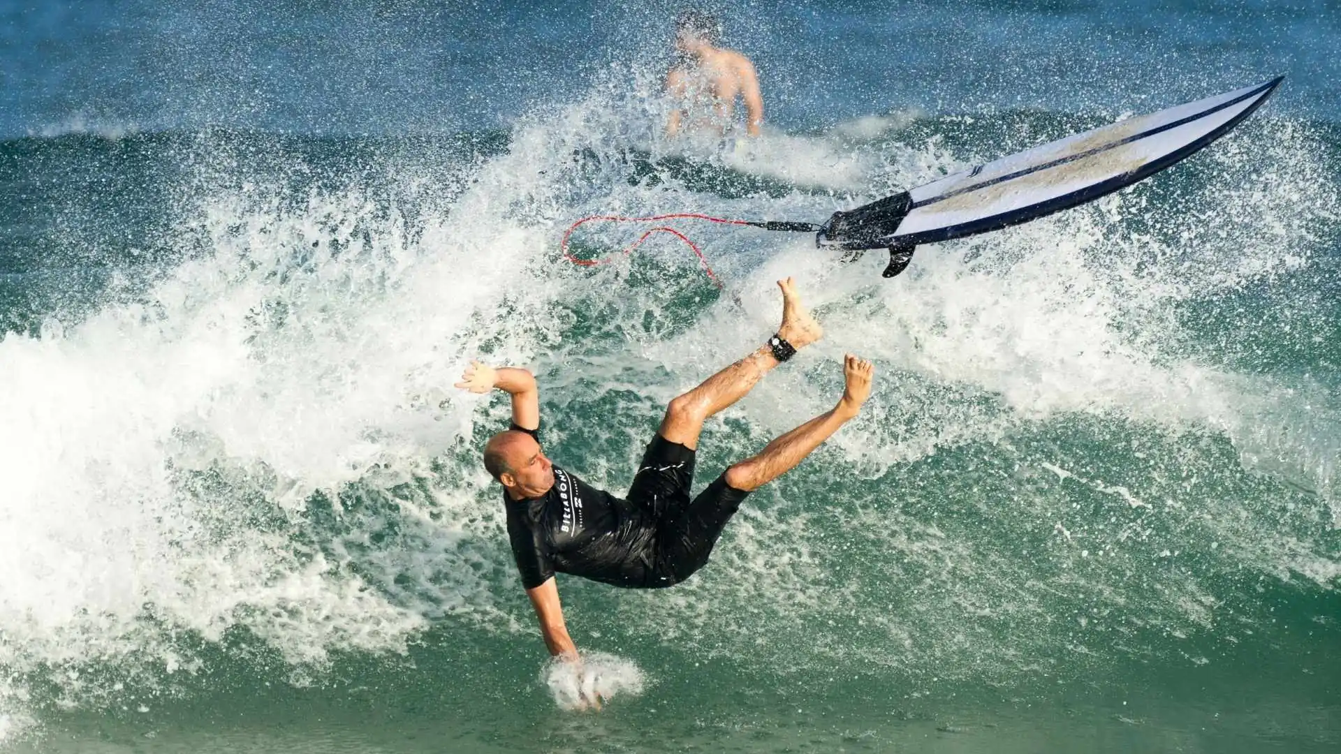 Surfboard on a tropical beach representing surf injury risks